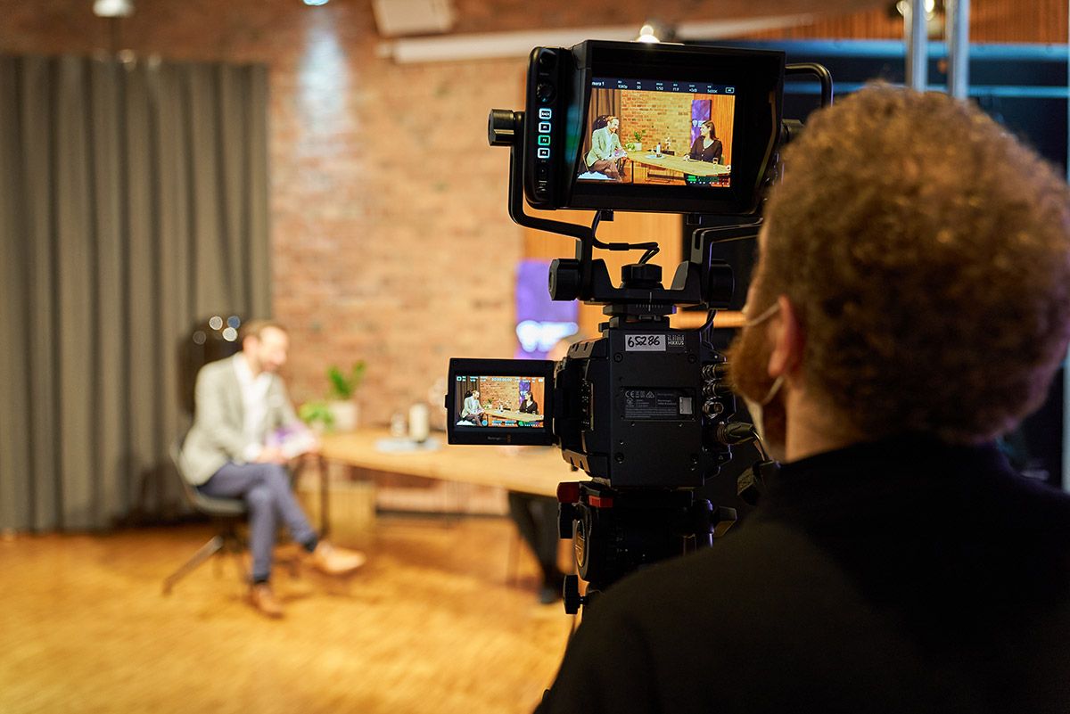 Kamera filmt ein Interview bei einer hybriden Veranstaltung