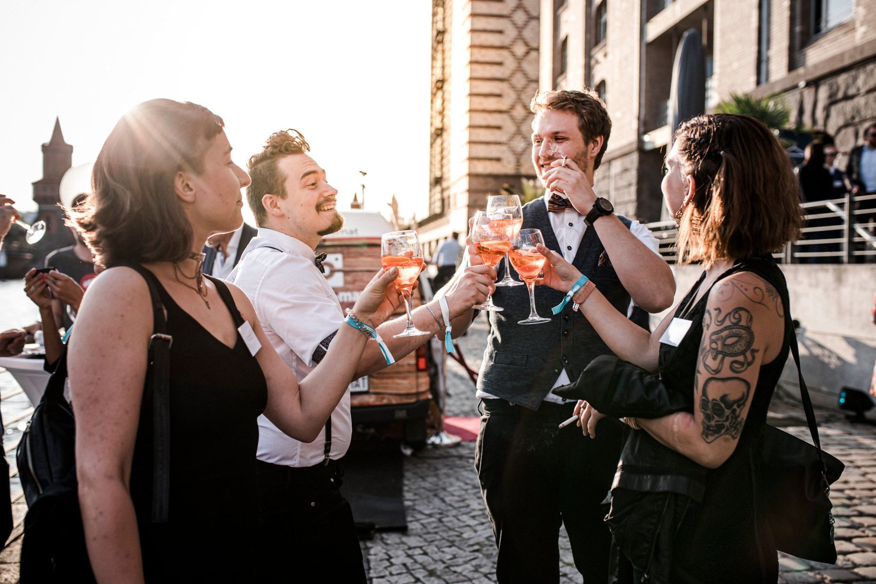 Gäste stoßen mit Aperol Spritz auf der Uferpromenade an